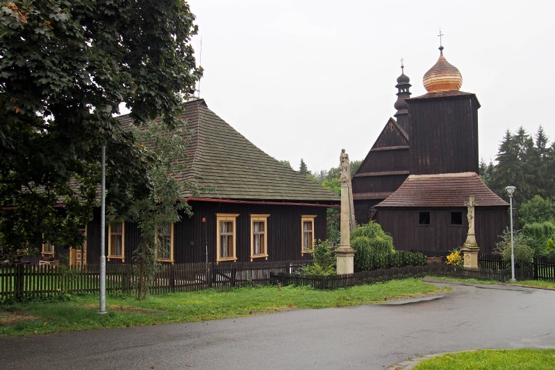 Kostel s farou a zvonicí.